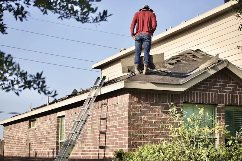 Professional roofer working on a residential roof in Yacht Club Estates